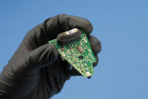 Removed PCB with buttons & gasket - you can see the sheen of the conformal coating