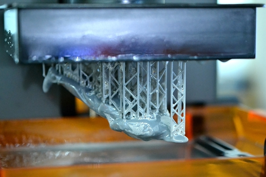 Stereolithography DPL 3d printer create detail and liquid drips, platform slowly move with liquid close-up. Progressive modern additive technology 3D printing, create scaled model by UV polymerization